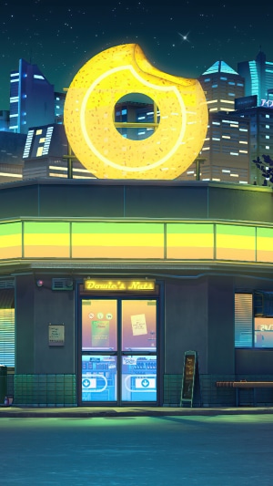 Donut shop sign at night in a city