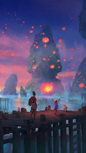 People watching sky lanterns over water at night