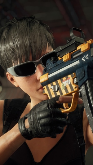 Woman with sunglasses holding a gun