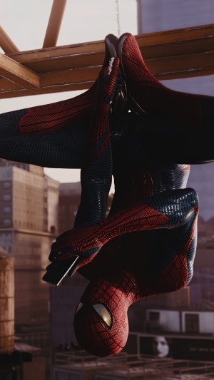 Spider-Man hanging upside down and using a smartphone