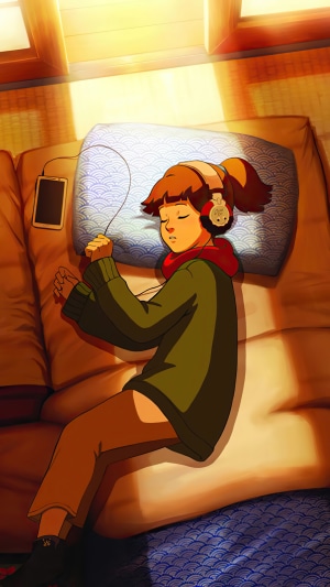 Girl listening to music on headphones while sleeping