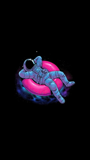 Astronaut relaxing on a pink inflatable ring in space