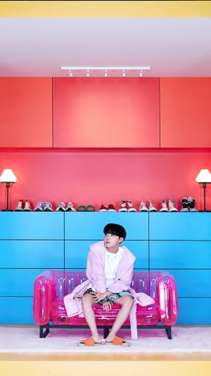 J-Hope from BTS sitting on a pink couch