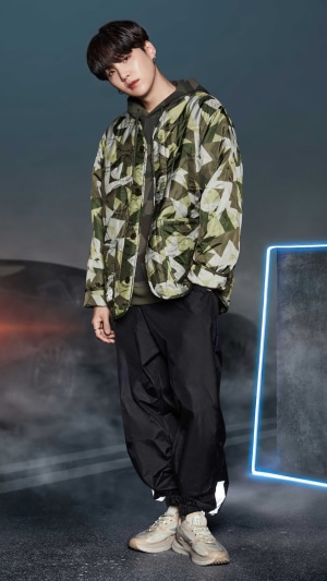 Suga from BTS posing in a photoshoot