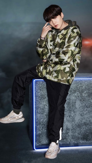 Suga from BTS posing in a photoshoot
