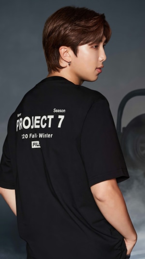 RM from BTS wearing a black Fila t-shirt