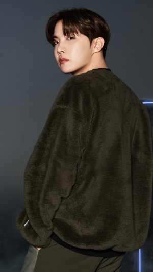 J-Hope from BTS in a dark green fuzzy sweater