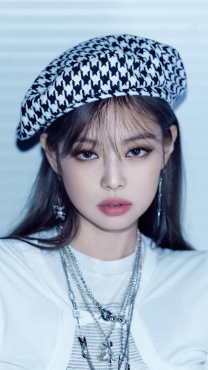 Jennie from BLACKPINK wearing a houndstooth beret and necklaces