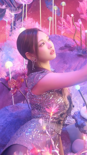 Ningning from Aespa in a futuristic, colorful landscape