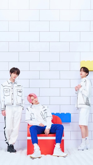 TXT members in white outfits with black outlines