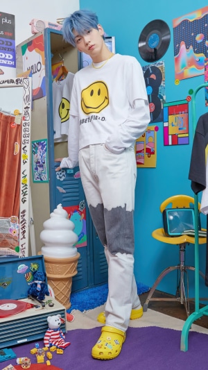 Soobin from TXT wearing a smiley face shirt