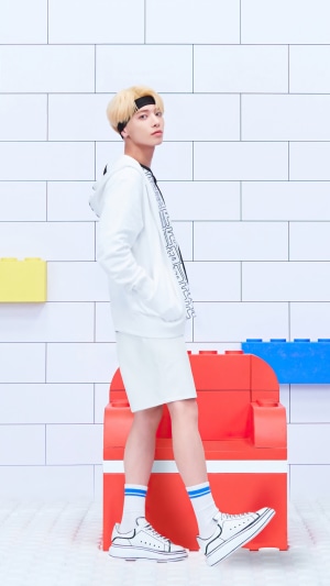 Taehyun from TXT posing in white outfit