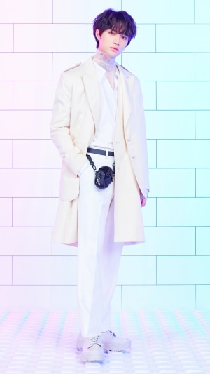 Beomgyu from TXT in a white suit