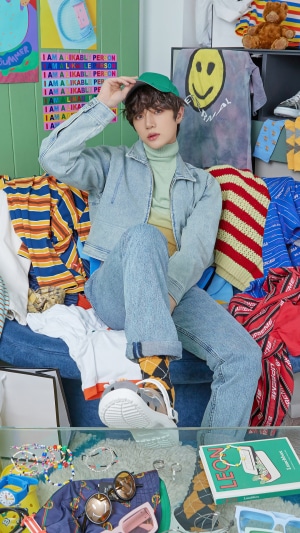 Beomgyu from TXT wearing denim and a green cap