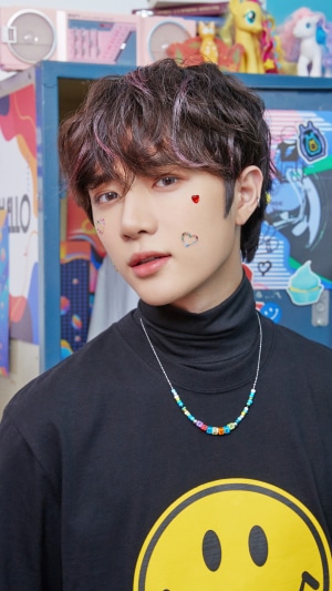 Beomgyu from TXT wearing a black turtleneck and necklace