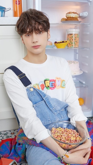 Huening Kai from TXT holding a bowl of cereal