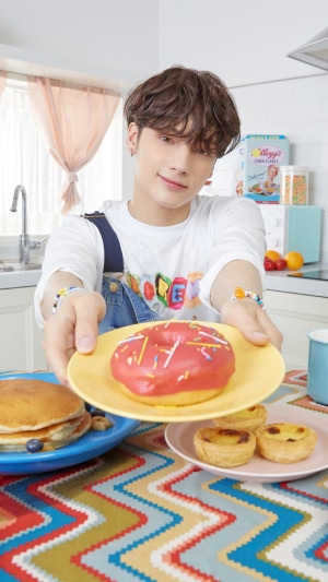 Huening Kai from TXT holding a donut