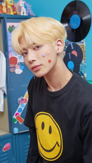 Taehyun from TXT with smiley face stickers