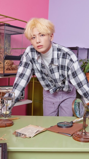 Taehyun from TXT in a plaid shirt