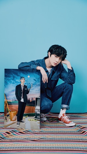Beomgyu from TXT posing with a photo