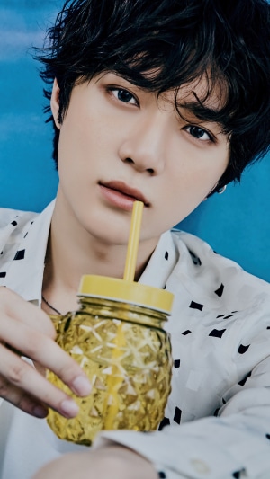 Beomgyu from TXT holding a pineapple-shaped glass
