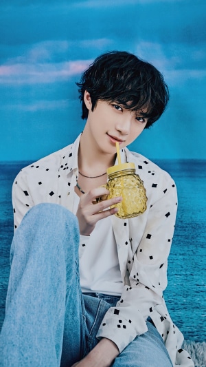 Beomgyu from TXT holding a pineapple-shaped drink