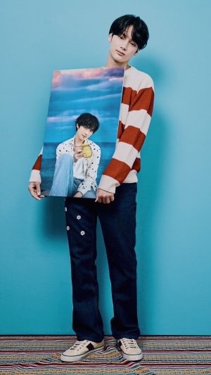 Huening Kai from TXT holding a photo