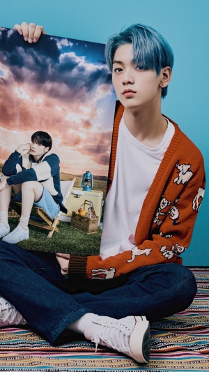 Soobin from TXT holding a photo