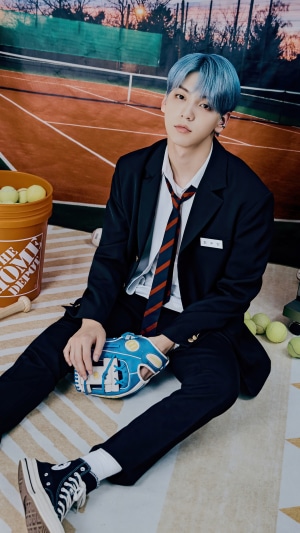 Soobin from TXT on a tennis court with baseball gear