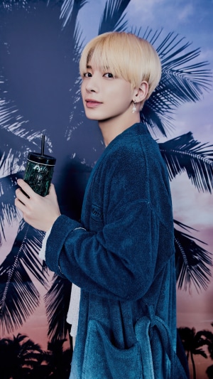 Taehyun from TXT holding a drink