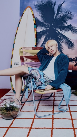 Taehyun from TXT in a beach-themed photoshoot