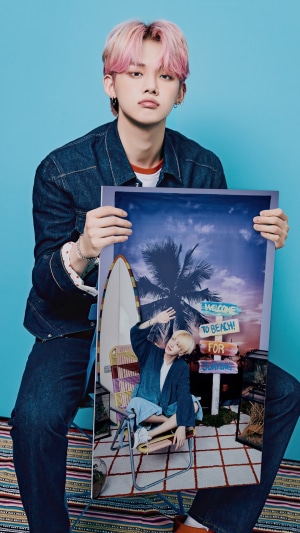 Yeonjun from TXT holding a photoshoot picture