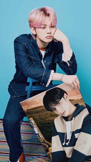 Yeonjun from TXT holding a photo