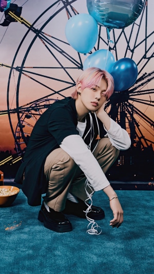 Yeonjun from TXT posing with balloons