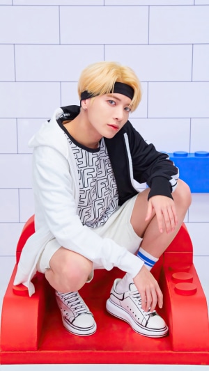 Taehyun from TXT wearing a black and white hoodie