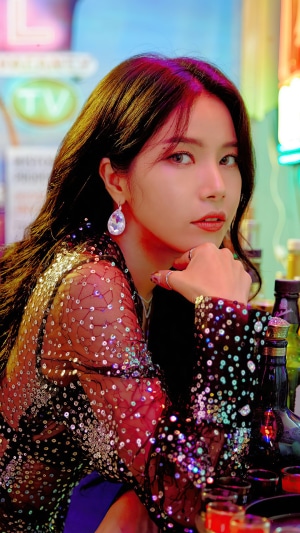 Solar from MAMAMOO posing in a sparkly outfit