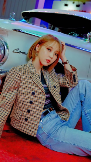 Moonbyul from MAMAMOO posing by a vintage car