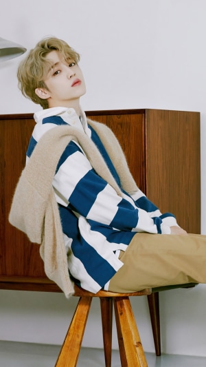 SCoups from Seventeen sitting on a stool