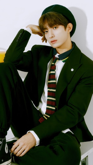 DK from Seventeen wearing a dark suit and beret