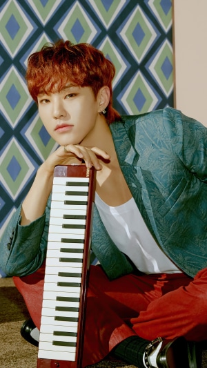 Hoshi from Seventeen holding a melodica