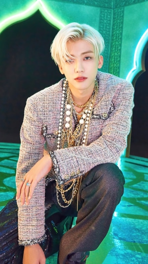 Jaemin from NCT posing in a tweed jacket and jewelry