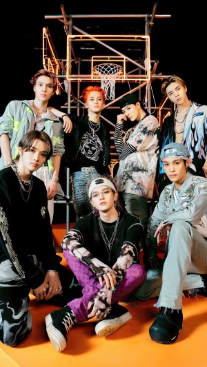 NCT U members posing in front of a basketball hoop