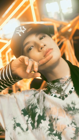 Jeno from NCT U wearing a New York Yankees cap