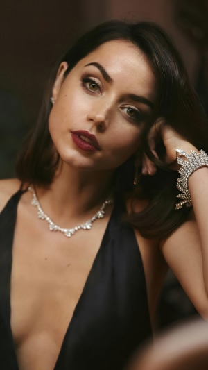 Ana de Armas wearing a black dress and jewelry
