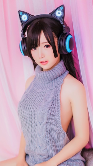 Asian girl with cat ear headphones wearing a sweater