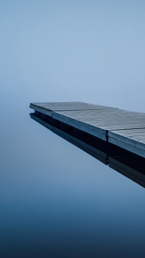 Dock on a calm lake with fog