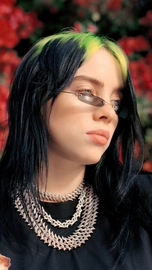 Billie Eilish with green streaks in hair and sunglasses