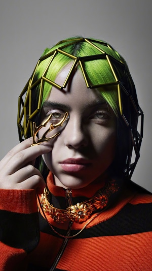 Billie Eilish with green hair and avant-garde jewelry