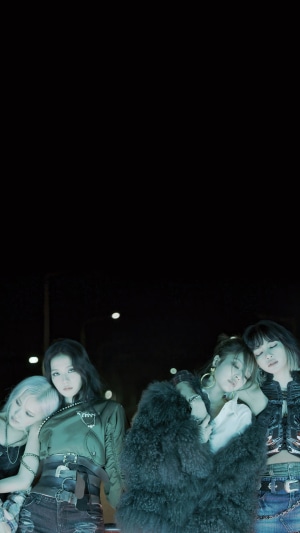 BLACKPINK members posing in dark setting