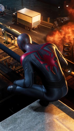 Spider-Man from Marvel's Spider-Man: Miles Morales crouches on a ledge